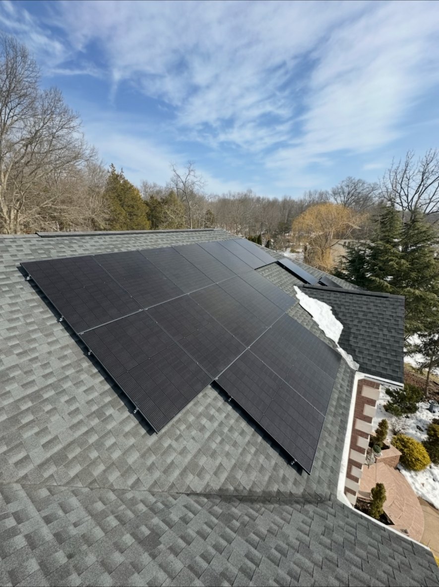 Aerial view of a 29 panel black solar array on a grey shingle roof home in Bridgewater, New Jersey