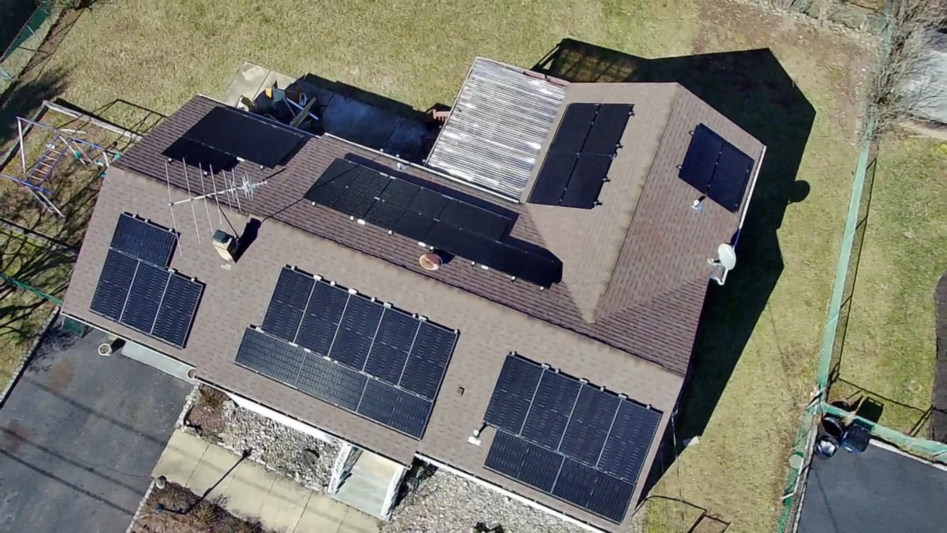 Aerial view of a 35 panel rooftop solar installation on a shingle roof home in Buena, New Jersey