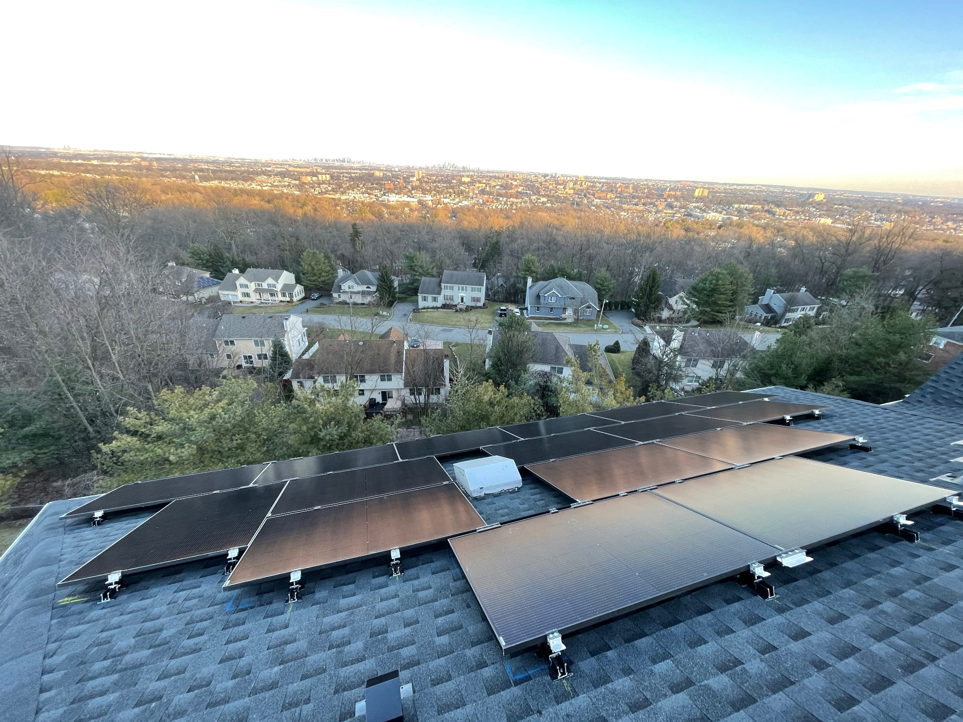 16 panel rooftop solar array overlooking the skyline from a home in West Orange, New Jersey