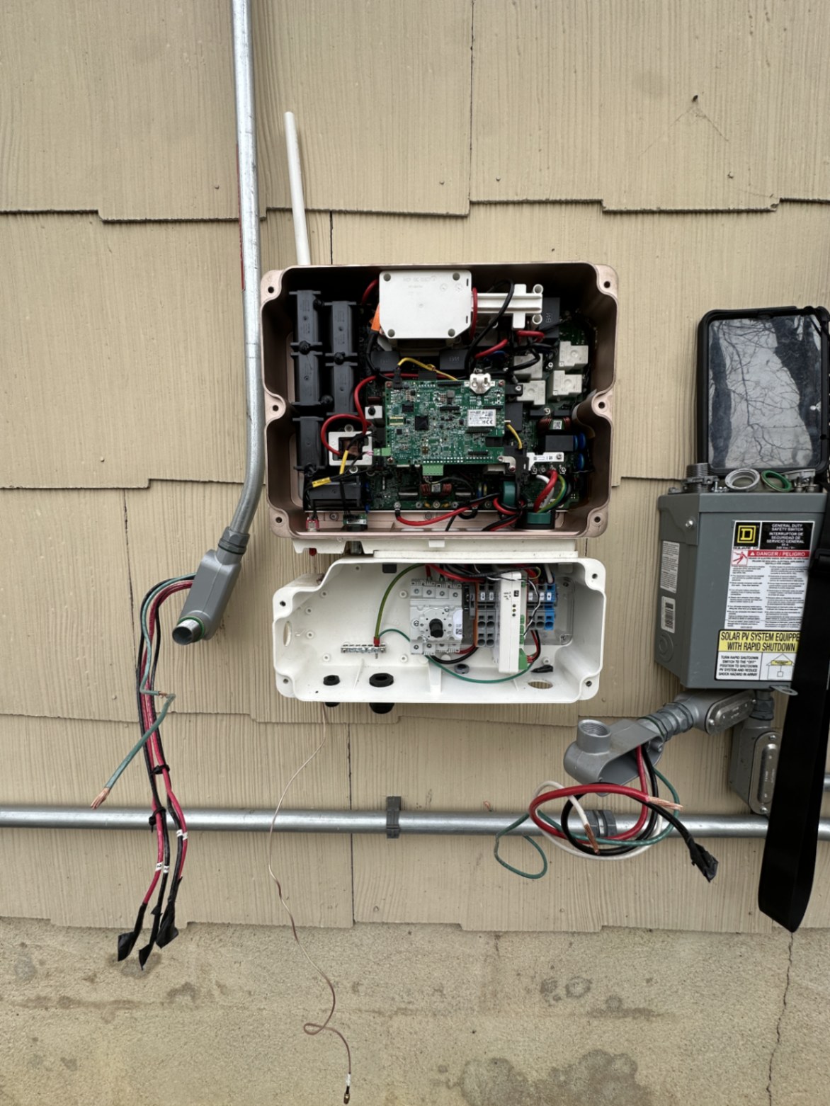 SolarEdge inverter opened for replacement on the exterior wall of a home in Yorketown, New Jersey