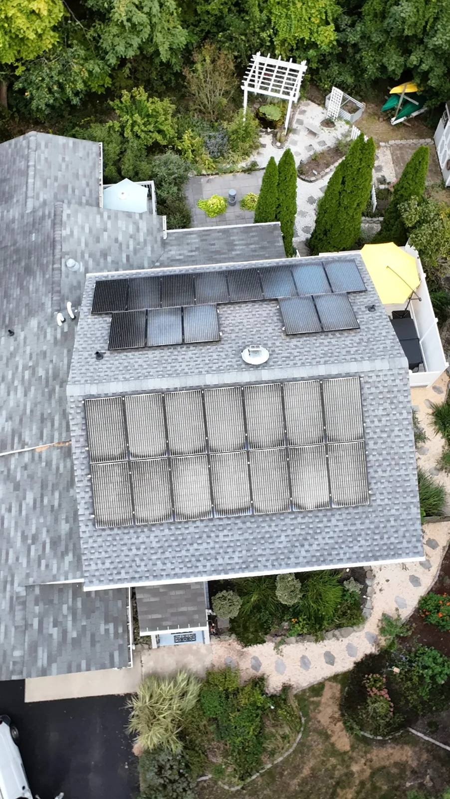 Aerial view of a completed 27-panel solar reinstallation on a newly replaced shingle roof in Cape May, New Jersey.