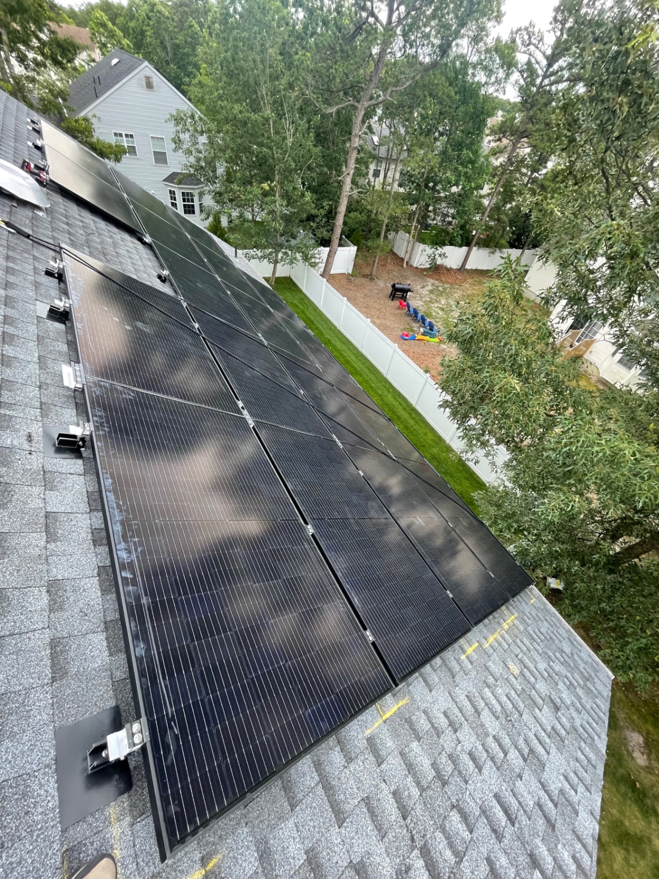 18 panel black solar array installed along the edge of a shingle roof in Egg Harbor, New Jersey