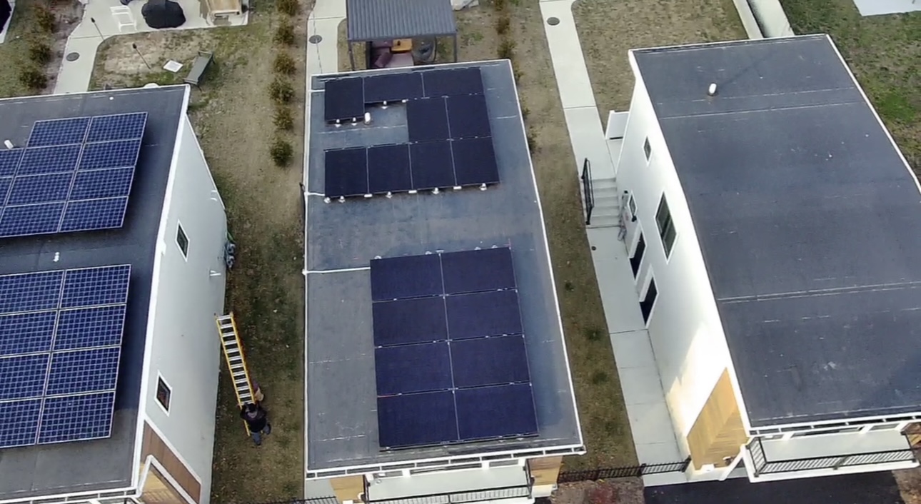 Aerial view of solar panel arrays on a flat roof home in Asbury Park, New Jersey